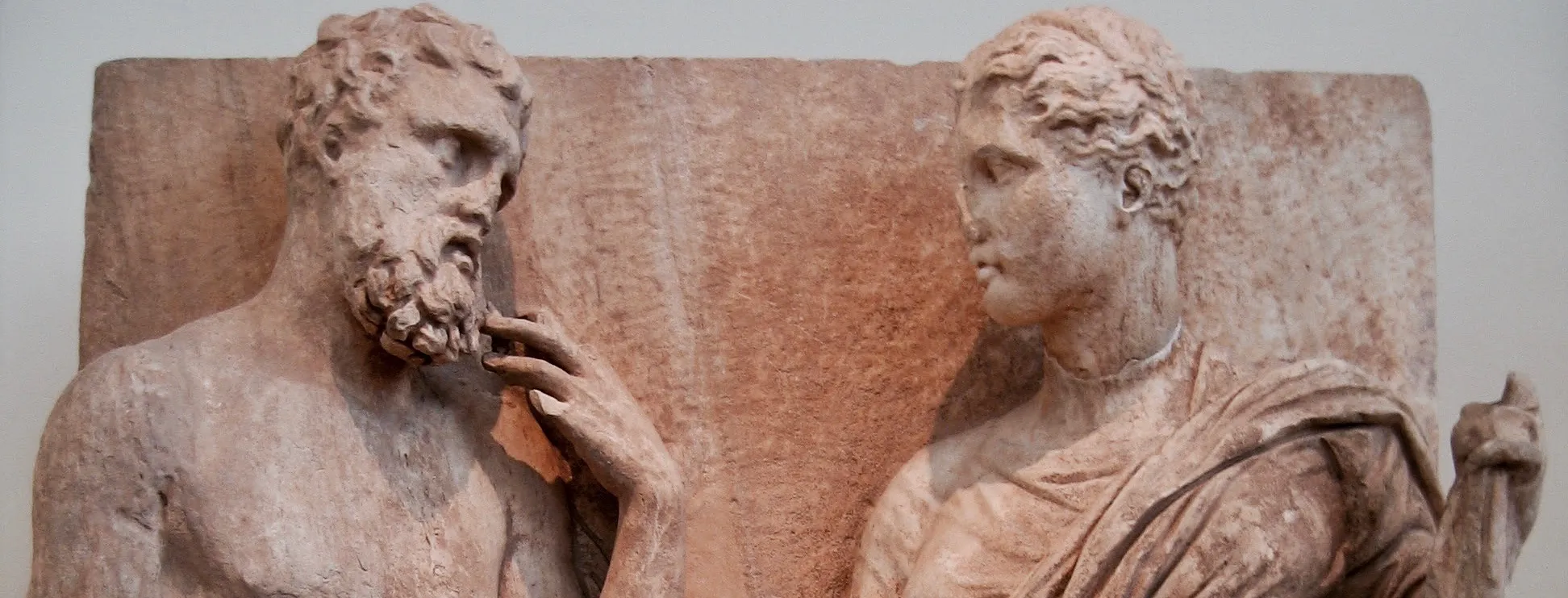 Two classical stone figures facing each other