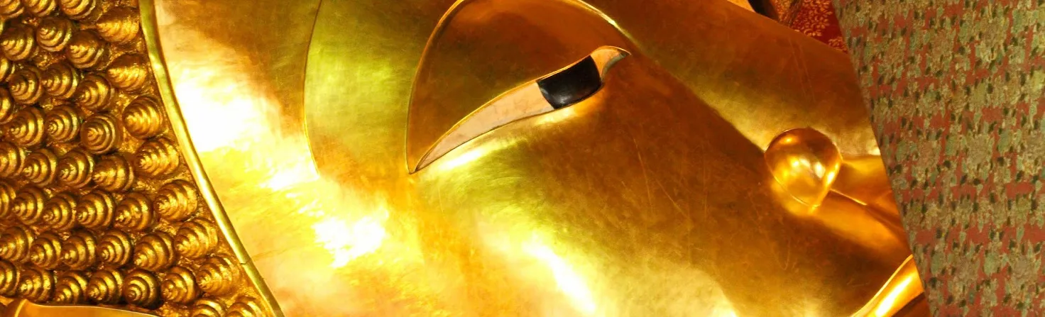 Close-up of a golden Buddha statue’s face